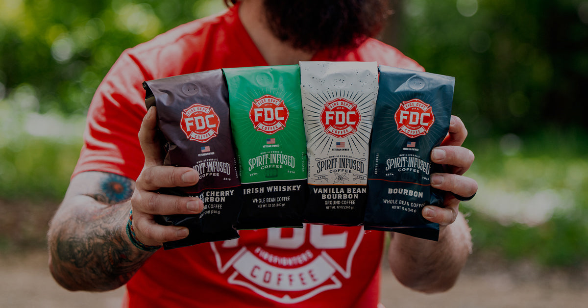 Image of a person holding four Spirit Infused Coffee Bags.